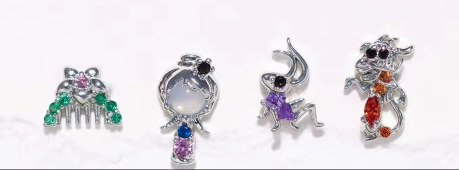 Four colorful Disney princess inspired-shaped charms on a gradient background